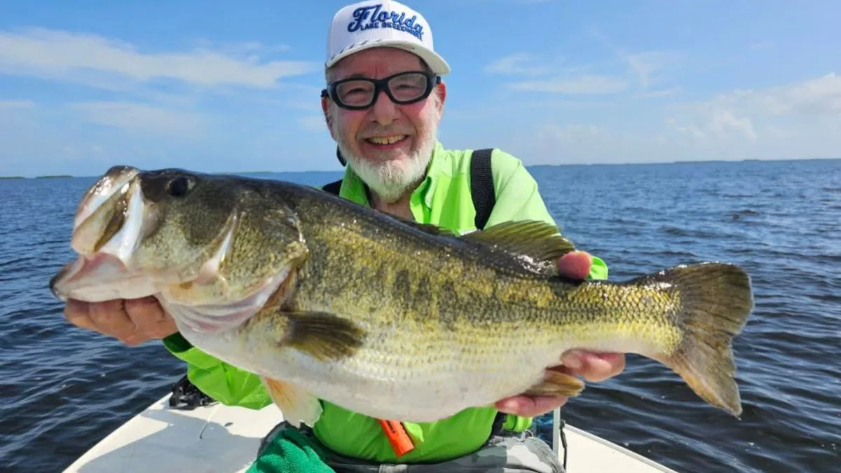 Angler with a large Lake Okeechobee largemouth bass